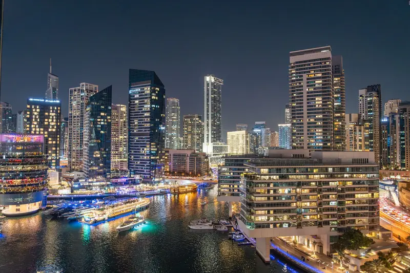 Dubai Marina towers reflected in the water at night