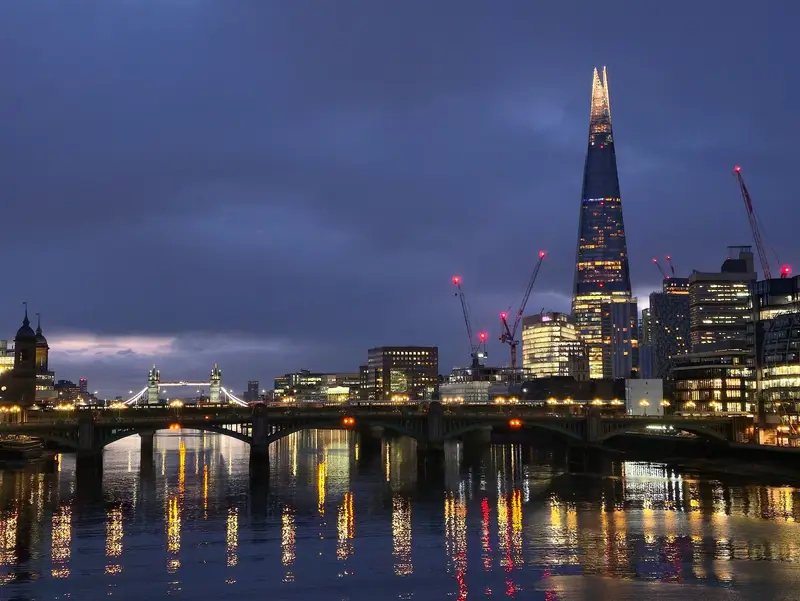 London skyline with the Shard beside the River Thames at dusk