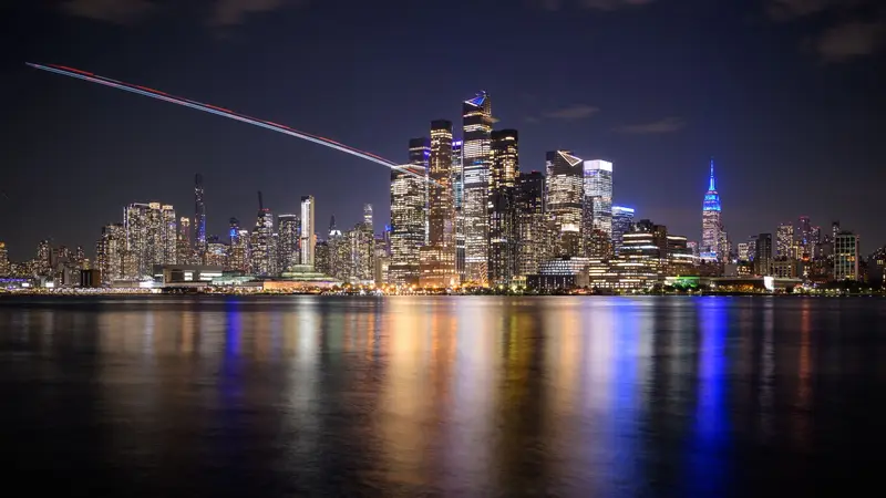 Manhattan skyline at night seen across the river